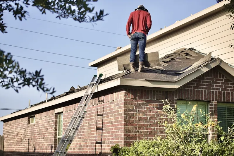 Professional roofer working on a residential roof in Madison Heights